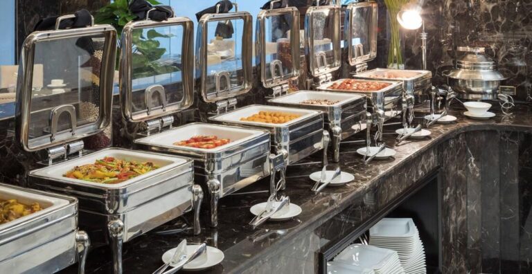 Commercial chafing dishes arranged along a hotel buffet line