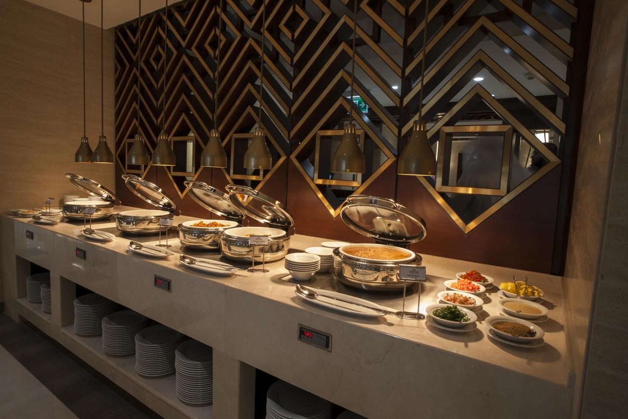 Hotel buffet setup with round and oval chafing dishes